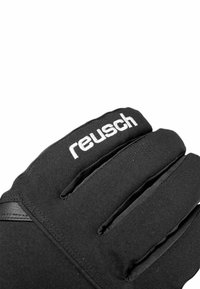 Schwarze Handschuhe aus weichem Material mit segmentierten Fingern. Auf der Rückseite befindet sich das weiße "Reusch"-Logo und eine strukturierte Griffzone auf der Handfläche.