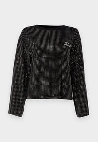 Juodas trumpas megztinis su apvaliu iškirpimu ir ilgomis rankovėmis, papuoštas metaliniais kabliukais ir mažuoju siuvinėtu logotipu.