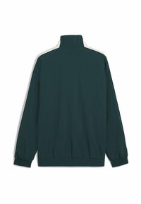 Donkergroene lichtgewicht jas met een hoge kraag, elastische manchetten en contrasterende gebroken witte accenten langs de schouders en de rits.