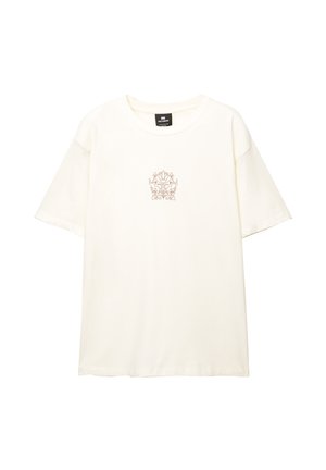 Cremefarvet bomulds t-shirt med rund halsudskæring og korte ærmer. Har en delikat, blomstret broderi i midten.