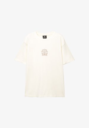 Cream-colored cotton t-shirt with a round neckline and short sleeves. Features a delicate, floral embroidery at the center.