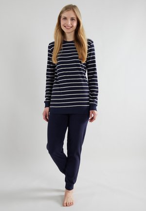 Navy blue loungewear set featuring a long-sleeve, striped top with light stripes and matching solid-colored joggers. Soft, relaxed fit.