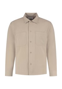 Beige overhemd met lange mouwen voorzien van twee voorzakken, knoopsluiting en een kraag. Gemaakt van een gladde, gestructureerde stof.