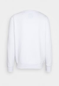 Sweat-shirt blanc à manches longues avec poignets et ourlet côtelés, vu de dos sur un fond uni gris clair.