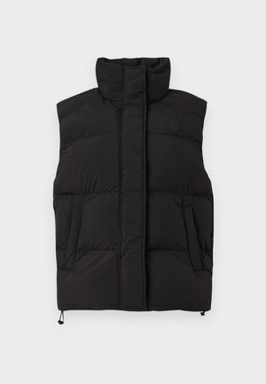 Black puffer vest with high collar, two side pockets, and a logo on the chest. Quilted texture with a rounded bottom and adjustable hem.