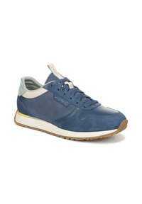 Vionic sneakers in marineblauw met lichtgrijze accenten, met een gestructureerde suede en gladleren bovenwerk, ronde neus en een contrasterende witte zool.