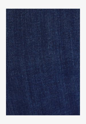 Tissu en denim bleu foncé avec une texture lisse, présentant des variations subtiles et un léger éclat. Aucun motif ou accent visible.