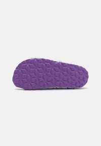 Suola in gomma viola con un motivo esagonale, progettata per aderenza e durata. Parte superiore colorata visibile sul bordo, realizzata in materiali tessili.