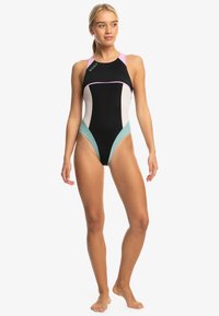 Black swimsuit with multi-colored accents in pink, white, and teal. Features a racerback design and a streamlined, sporty cut.