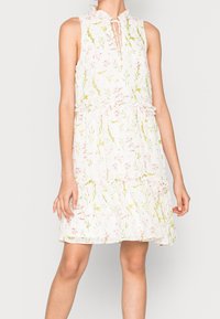 White floral dress with ruffled collar and keyhole detail. Features green and pink flower patterns, layered ruffle skirt, and lightweight fabric.