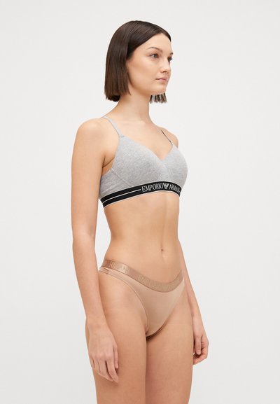 Gray soft fabric bra with thin straps and black band featuring "Emporio Armani". Beige thong with matching logo band on the waist.