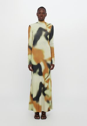 Midi dress made of stretchy fabric featuring a multicolored abstract pattern in green, orange, and black; high neck and long sleeves.