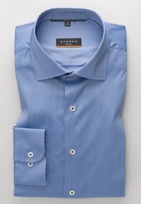Camicia da uomo azzurro chiaro a taglio aderente, piegata ordinatamente con colletto appuntito e bottoni bianchi sul davanti e sui polsini.