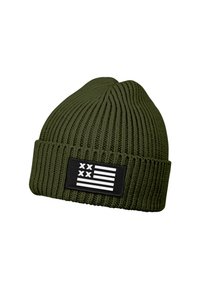 Green knit beanie with vertical ribbing, featuring a black patch displaying a stylized white flag design. Soft texture and foldable cuff.