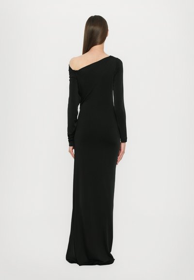 Black, form-fitting, long-sleeve dress with an asymmetric neckline and a smooth, stretchy texture, falling to the ankles.
