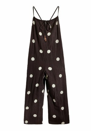 Schwarzer ärmelloser Jumpsuit mit weitem Bein, weißen Polka-Dots, verstellbaren Spaghettiträgern und einer vorderen Schleife mit Holzperlen.