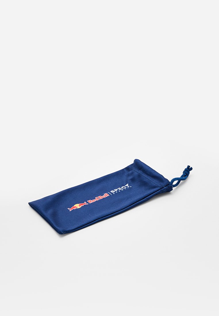 Granatowa torba materiałowa z zamknięciem na ściągacz, z logo Red Bull i napisem "SPECT" w kolorze białym. Gładka tekstura, prostokątny kształt.