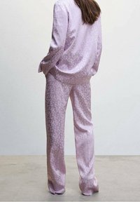 Lilac satin pajama set featuring a patterned design of subtle dots. The jacket has a relaxed fit, and the pants are straight-leg with a smooth texture.