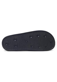 Zwarte rubberen schoen zool met een gestructureerd oppervlak en cirkelvormige grip patronen, voorzien van verhoogde cirkelvormige accenten voor verbeterde grip.
