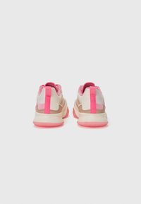 Sneakers with a beige and pink color scheme, featuring a textured design, pink accents, and a cushioned sole. The heel includes reflective detail.