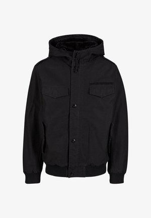 Veste extérieure noire avec une fermeture éclair à l'avant, deux poches poitrine, une capuche, des poignets et un ourlet côtelés, et une texture de tissu lisse et durable.