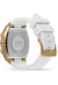 Correa de reloj de silicona blanca con patrón en relieve, fondo de acero inoxidable dorado y herrajes, y un movimiento Miyota; resistencia al agua de 5ATM.