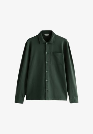 Mørkegrøn skjorte med knapper, krave, brystlomme og lange ærmer. Glat stof med en klassisk pasform og en subtil glans.