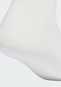 White cotton sock with a smooth texture and fine knit detailing, featuring a contoured shape for foot coverage.