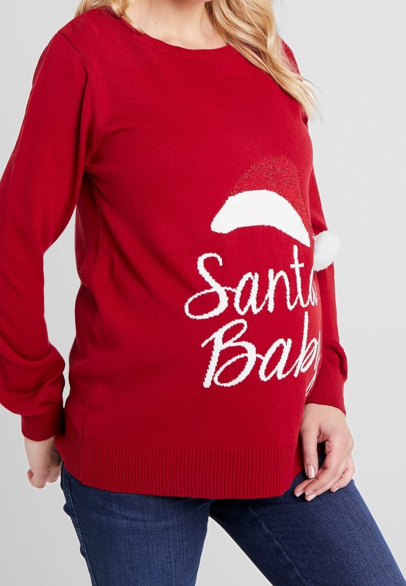 Red knit sweater featuring white "Santa Baby" text, a Santa hat design, ribbed cuffs, and hem. Soft texture suitable for winter wear.