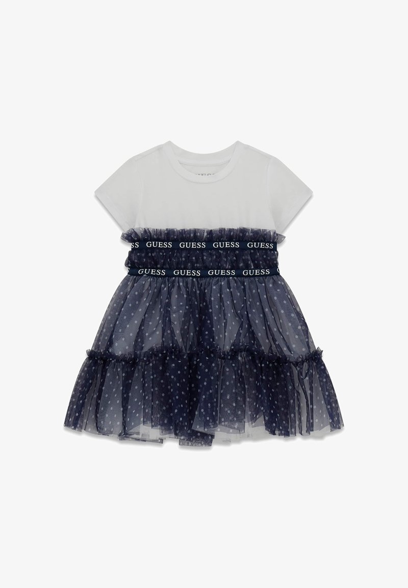 Hvid bomulds-T-shirt med navy tylskørt. Skørtet har polkaprikker og flæsekant med elastik i taljen med mærke.