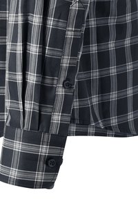 Camicia a maniche lunghe a quadri neri e bianchi con polsino e placca della manica dotati di due bottoni neri.