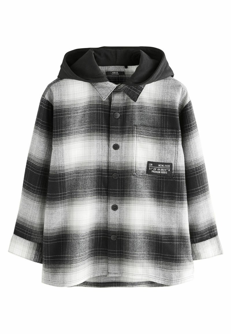 Chemise à carreaux noir et blanc avec capuche, présentant une poche, une fermeture à boutons et un tissu texturé à motif à carreaux.