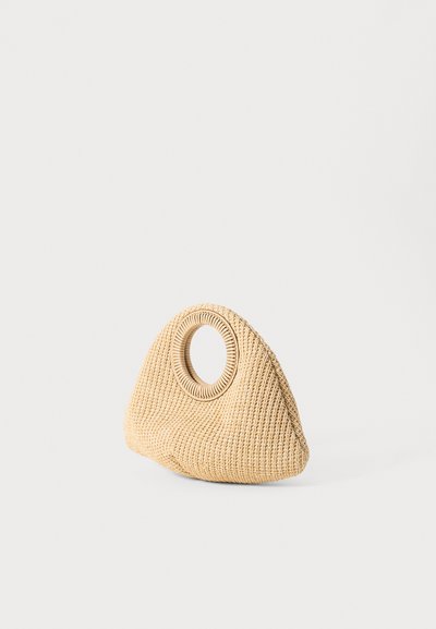 Woven beige handbag with a triangular shape and a circular cut-out handle. Textured surface with a natural fiber appearance.