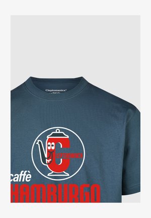 Dark blue crew-neck t-shirt featuring a large red circular logo with a teapot and text "Cleptomanick caffè HAMBURGO." Smooth cotton texture.