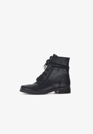 Black leather ankle boot with a rounded toe, lace-up design, and a height that reaches just above the ankle. Features a low heel and stitched accents.