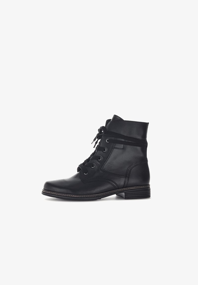 Bottes de cheville en cuir noir avec un bout rond, un laçage, un col rembourré et une semelle texturée. Présente des accents cousus le long des bords.