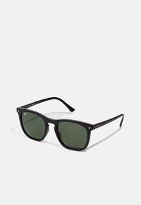 Black rectangular sunglasses with green lenses. Plastic frame features straight lines. Small metal accents near the hinges.