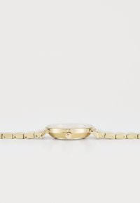 Montre-bracelet en métal doré avec un boîtier rond, lunette lisse et bracelet à maillons. Présente une couronne sur le côté et un cadran épuré.