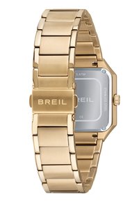 Guld rustfrit stål ur med flad led-ankert, ottekantet kasse og en gennemsigtig bagside, der viser mærkenavnet "BREIL." Vandafvisende op til 5 ATM.