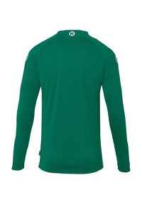 Langærmet skjorte i ensfarvet grøn stof med rund halsudskæring, der har et logo på bagkraven og et lille accentlogo på ærmet.