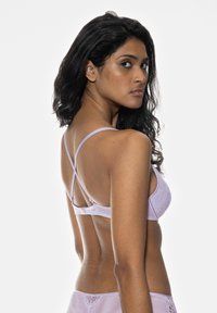 Purple lace bra with a mesh back and crisscross straps, featuring a scalloped trim along the edges and a hook-and-eye closure.