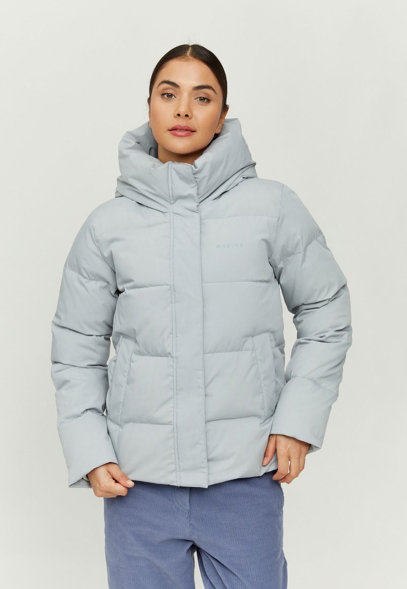 Light gray puffer jacket with a high collar and large hood, featuring quilted panels and front pockets. Smooth, water-resistant fabric.
