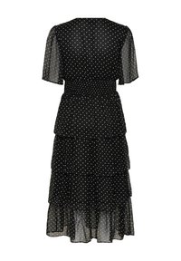 Robe midi noire à pois blancs, manches courtes transparentes, taille smockée et jupe volantée en plusieurs couches vue de dos.