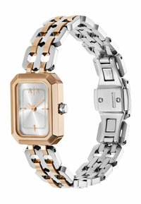 Obdelhý nerezový hodin s růžově zlatým rámečkem, stříbrným číselníkem a náramkem z vícolorového kovu s geometrickým vzorem.