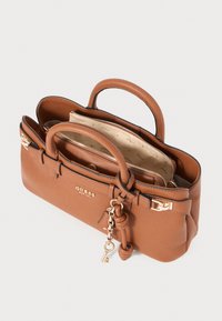 Brown textured leather handbag featuring dual handles, a gold-tone clasp, and interior pockets with a logo-patterned lining.