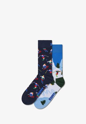 Pair of knee-high socks: one navy with skier pattern, the other light blue with mountain scene and green accents. Cotton blend material.