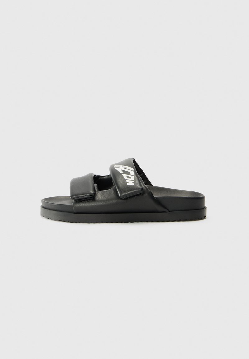 Mustad mustad sandaalid kahe reguleeritava rihmaga ja tekstuuriga tallaga, ühel rihmal on logo. Siledast sünteetilisest materjalist.