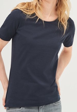 Navy blue cotton t-shirt with short sleeves, round neckline, and a relaxed fit. Features a smooth texture and slight side split at the hem.