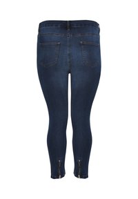 Donkerblauwe denim legging met een slim fit, voorzien van twee achterzakken en ritsaccenten bij de enkel. Glad oppervlak en rekbaar materiaal.