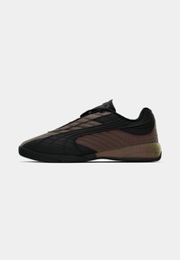 Sneaker de tip low-top, de culoare neagră și maro închis, cu talpă neagră și sistem de închidere cu șireturi, detalii pe lateral și o zonă texturată la călcâi.